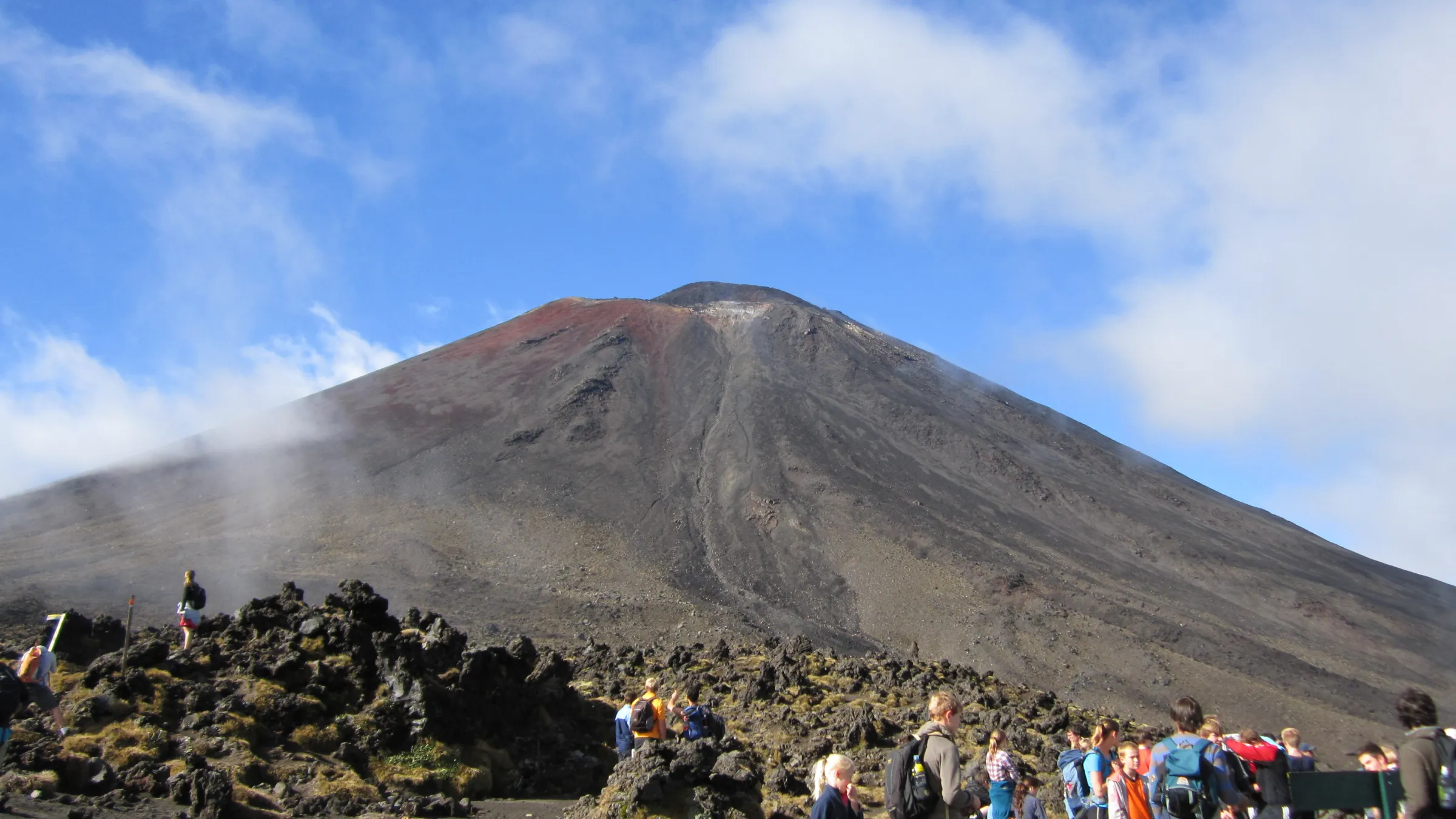 a group of people standing on top of a mountain
