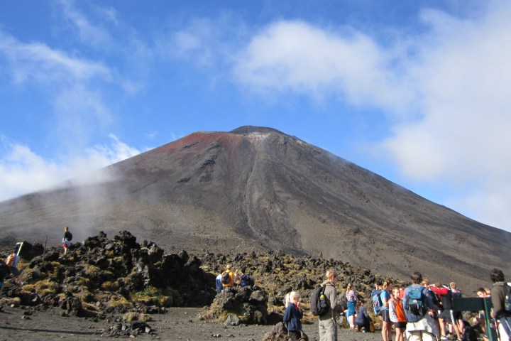 a group of people standing on top of a mountain