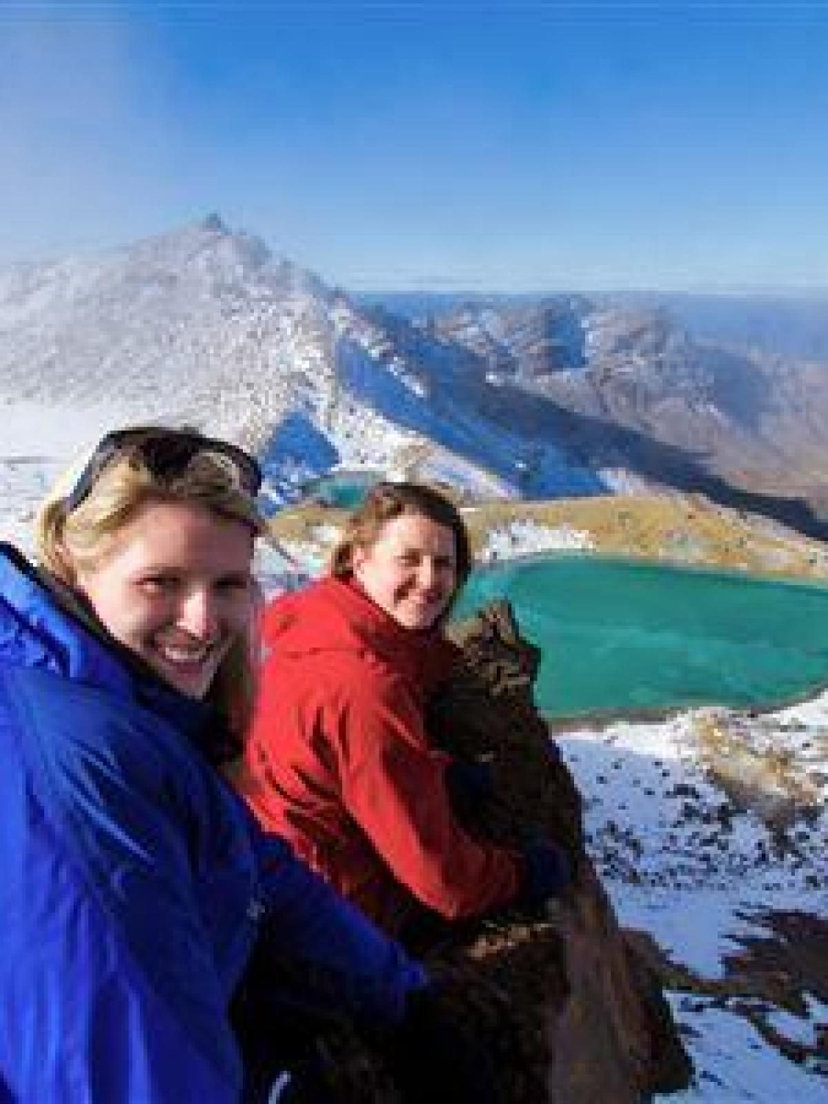 a person standing on top of a snow covered mountain