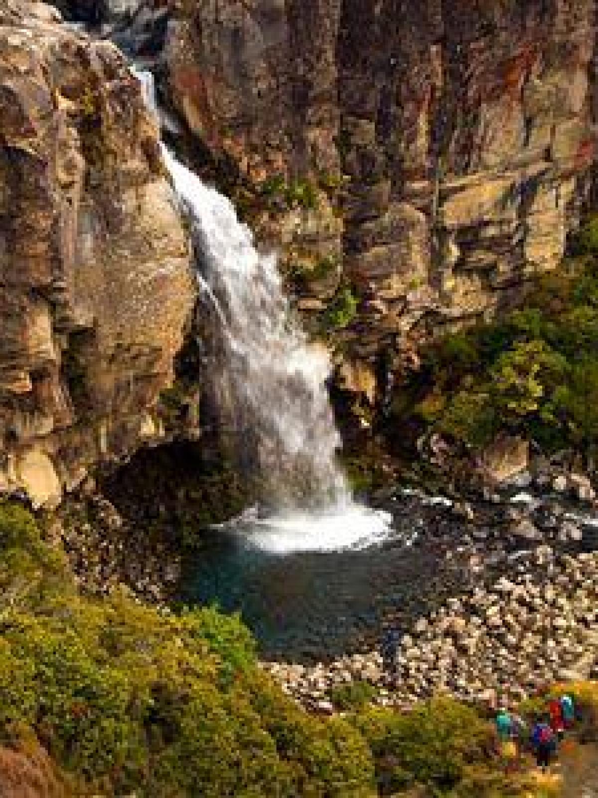 a large waterfall over a rocky cliff