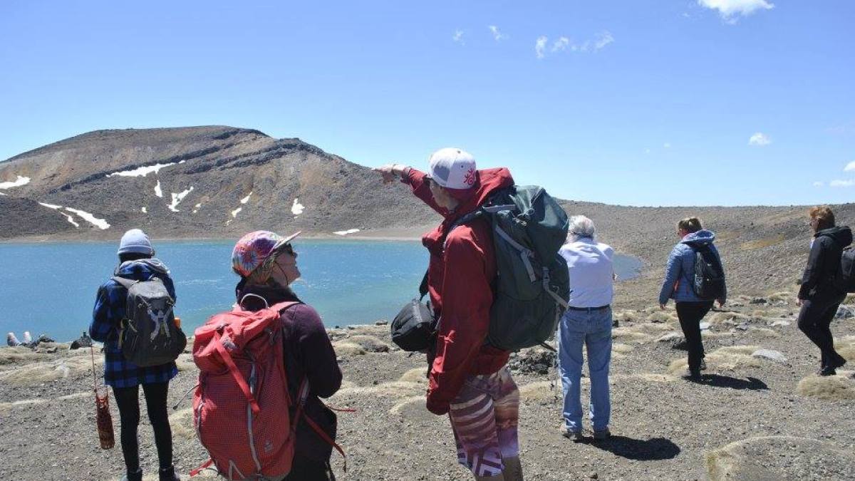 a group of people that are standing in the sand