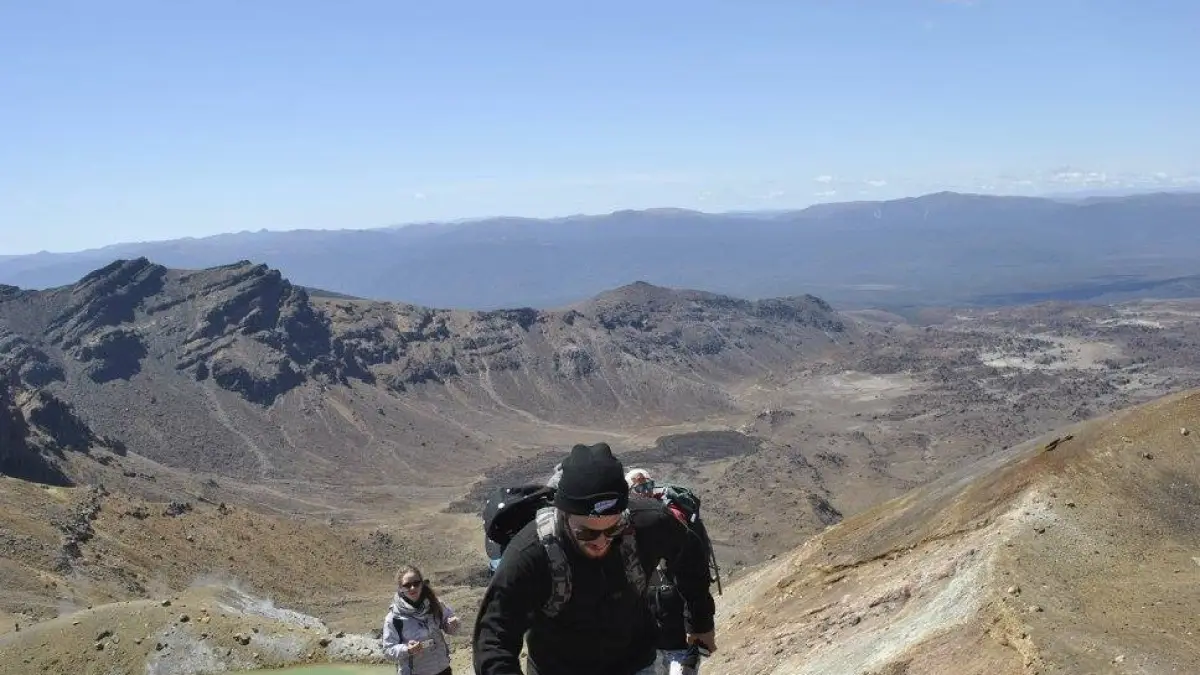 a man riding a motorcycle down a dirt road