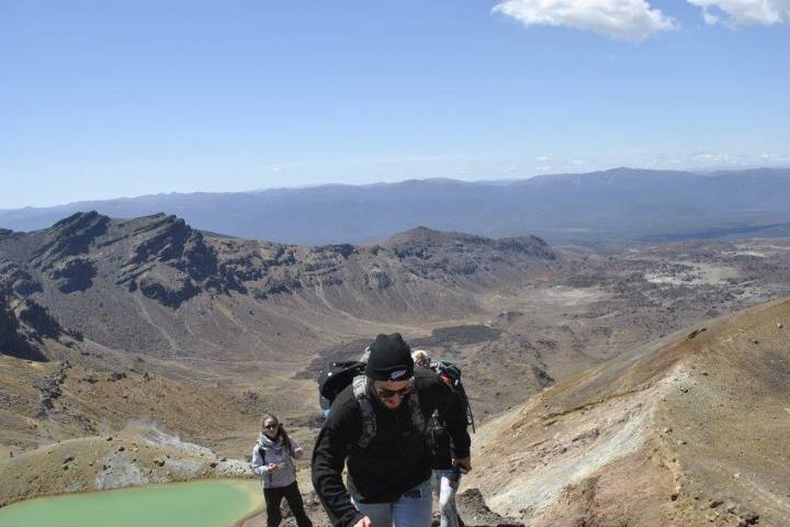 a man riding a motorcycle down a dirt road